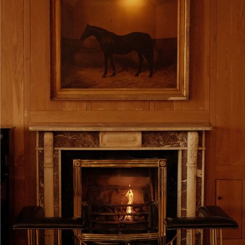 Fireplace in the sitting room of the luxury Dunraven Arms Hotel in County Limerick